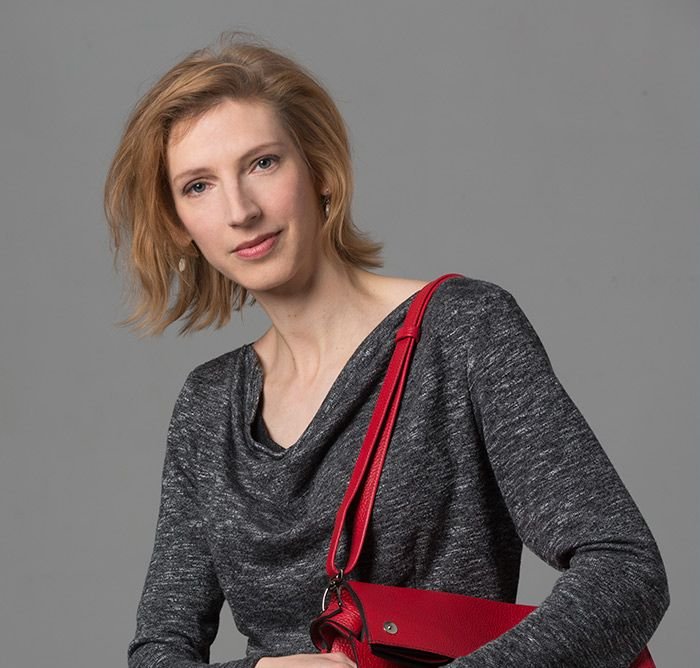 photo de la maroquinière de Cyclamelle, avec à l'épaule le 1e prototype du sac ARTEMISIA, rouge